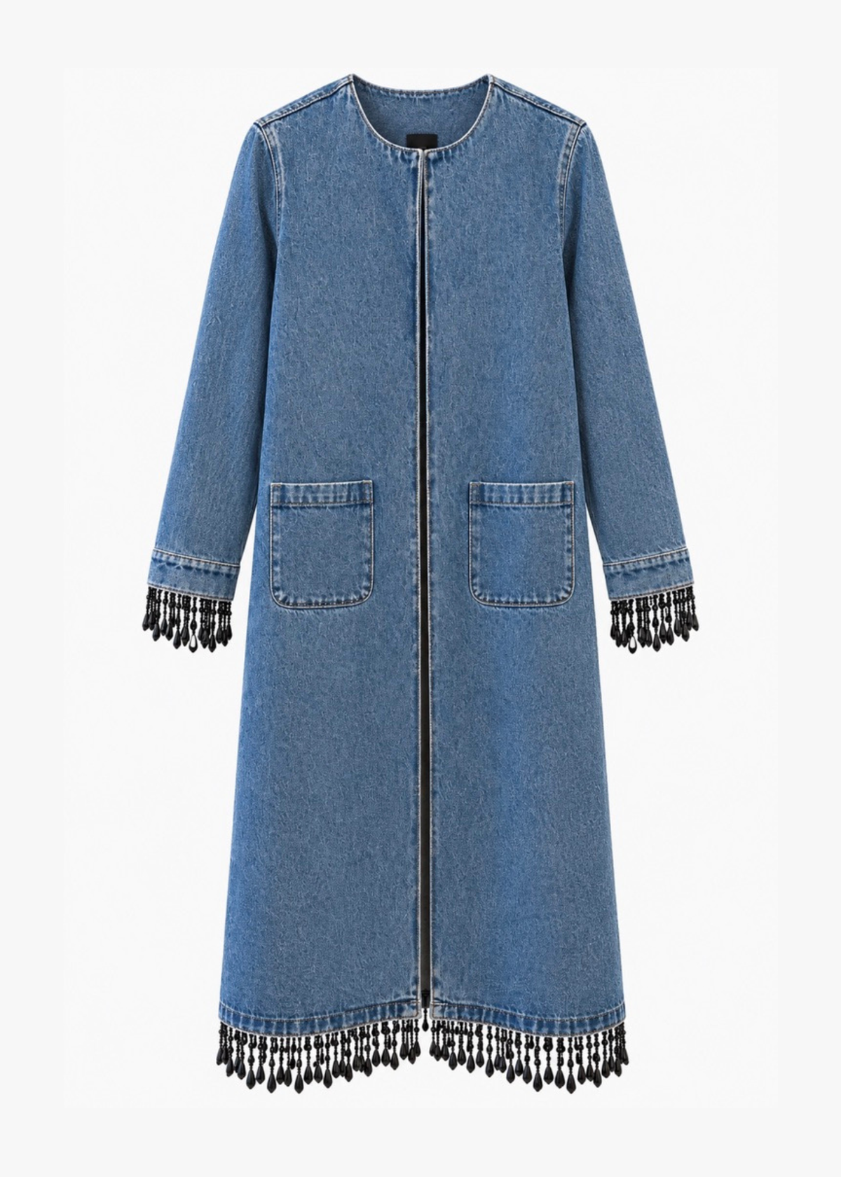 A blue denim longline coat with black fringe detailing along the hem and cuffs, displayed against a plain white background.